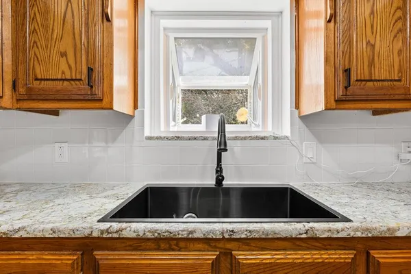 a view of kitchen sink window and cabinets