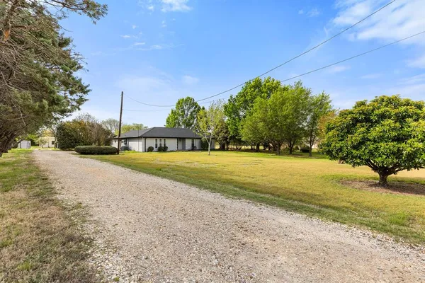 a view of swimming pool is middle in the garden