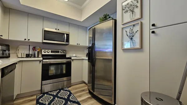 a kitchen with wooden cabinets and stainless steel appliances