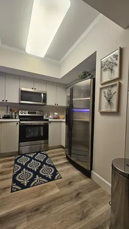 a bedroom with a bed and a flat tv screen on a dresser