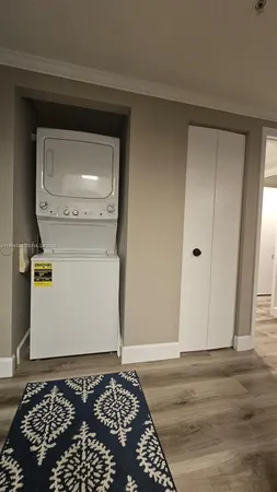 a bedroom with a bed window and a flat tv screen