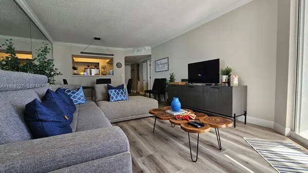 a living room with furniture and wooden floor