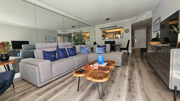 a living room with furniture and wooden floor