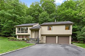 143 Mitchell Road Somers, NY 10589 - Photo 1 of 1 a front view of a house with a garden and plants