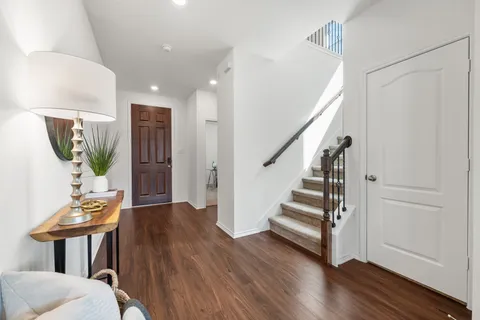 a view of entryway with wooden floor and stairs