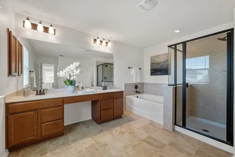 a large bathroom with a large mirror vanity and shower