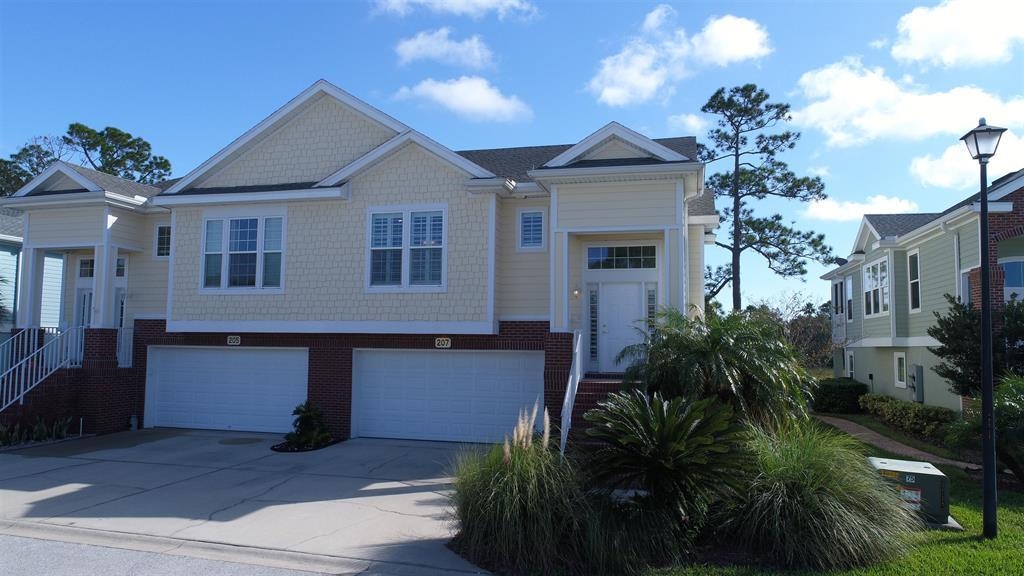207 Sunset Point St. Augustine, FL 32080 - Photo 17 of 59 a front view of a house with a garden