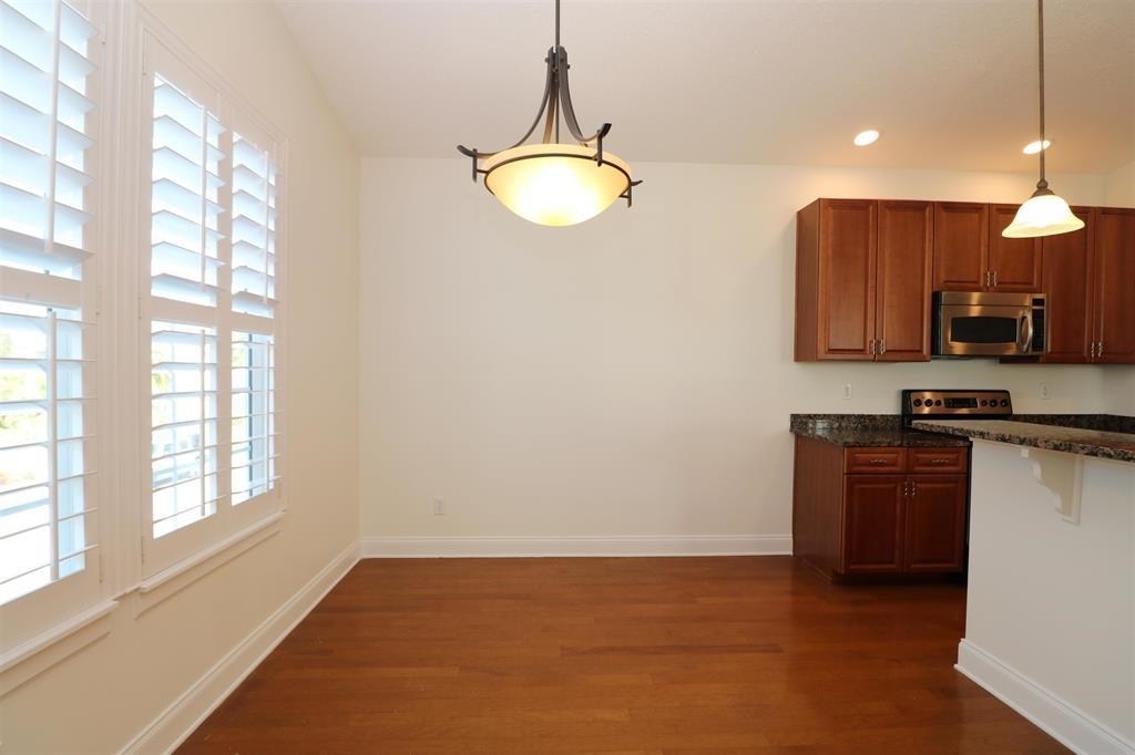 207 Sunset Point St. Augustine, FL 32080 - Photo 33 of 59 a kitchen with a refrigerator and a stove top oven