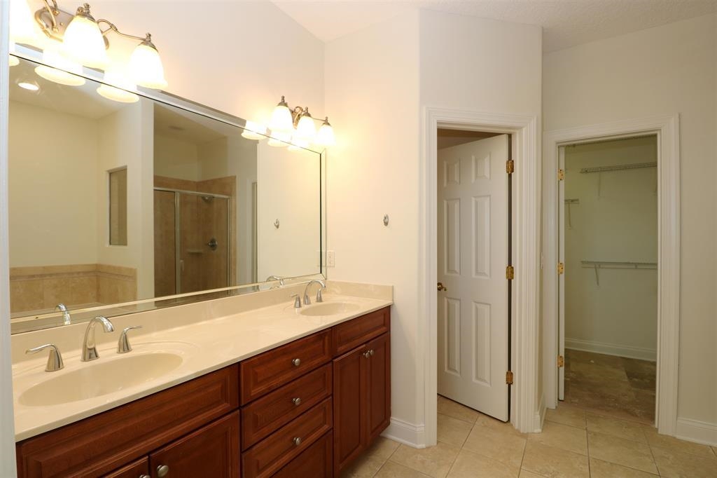 207 Sunset Point St. Augustine, FL 32080 - Photo 38 of 59 a bathroom with a double vanity sink shower and a mirror