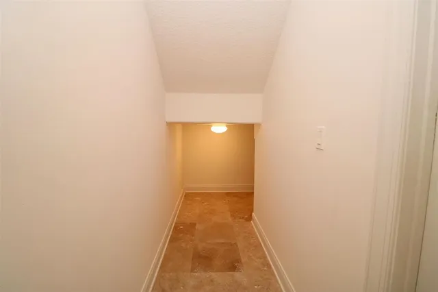 a view of a hallway with windows