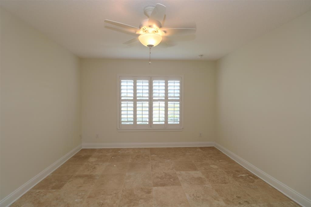 207 Sunset Point St. Augustine, FL 32080 - Photo 46 of 59 an empty room with a chandelier fan and windows