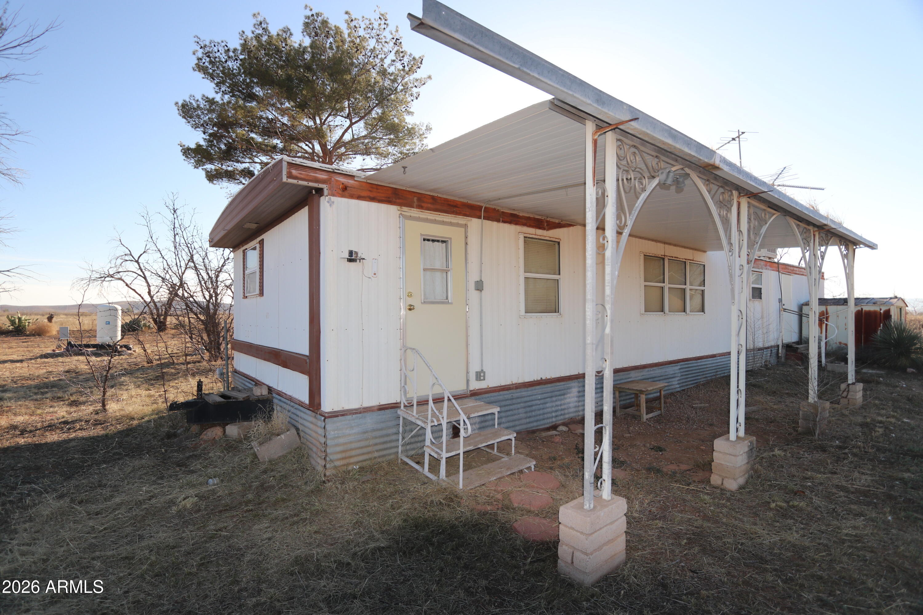 6286 East Mockingbird Road, Unit 8 Pearce, AZ 85625 - Photo 15 of 28 a backyard of a house with table and chairs