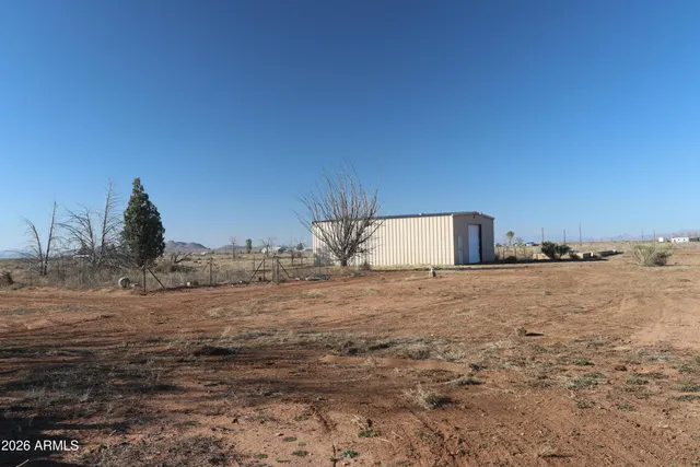 a view of a dry space with mountains in the background