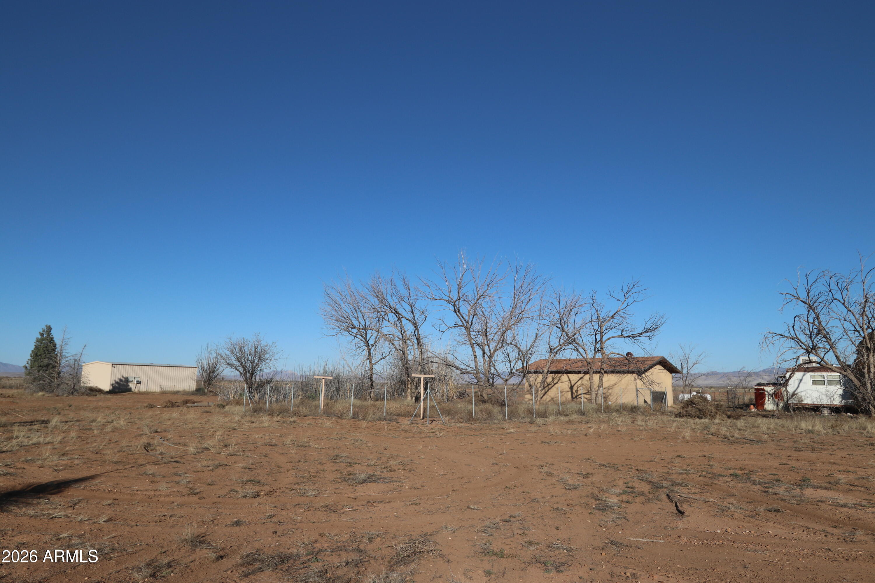 6286 East Mockingbird Road, Unit 8 Pearce, AZ 85625 - Photo 23 of 28 a view of a dry yard with trees