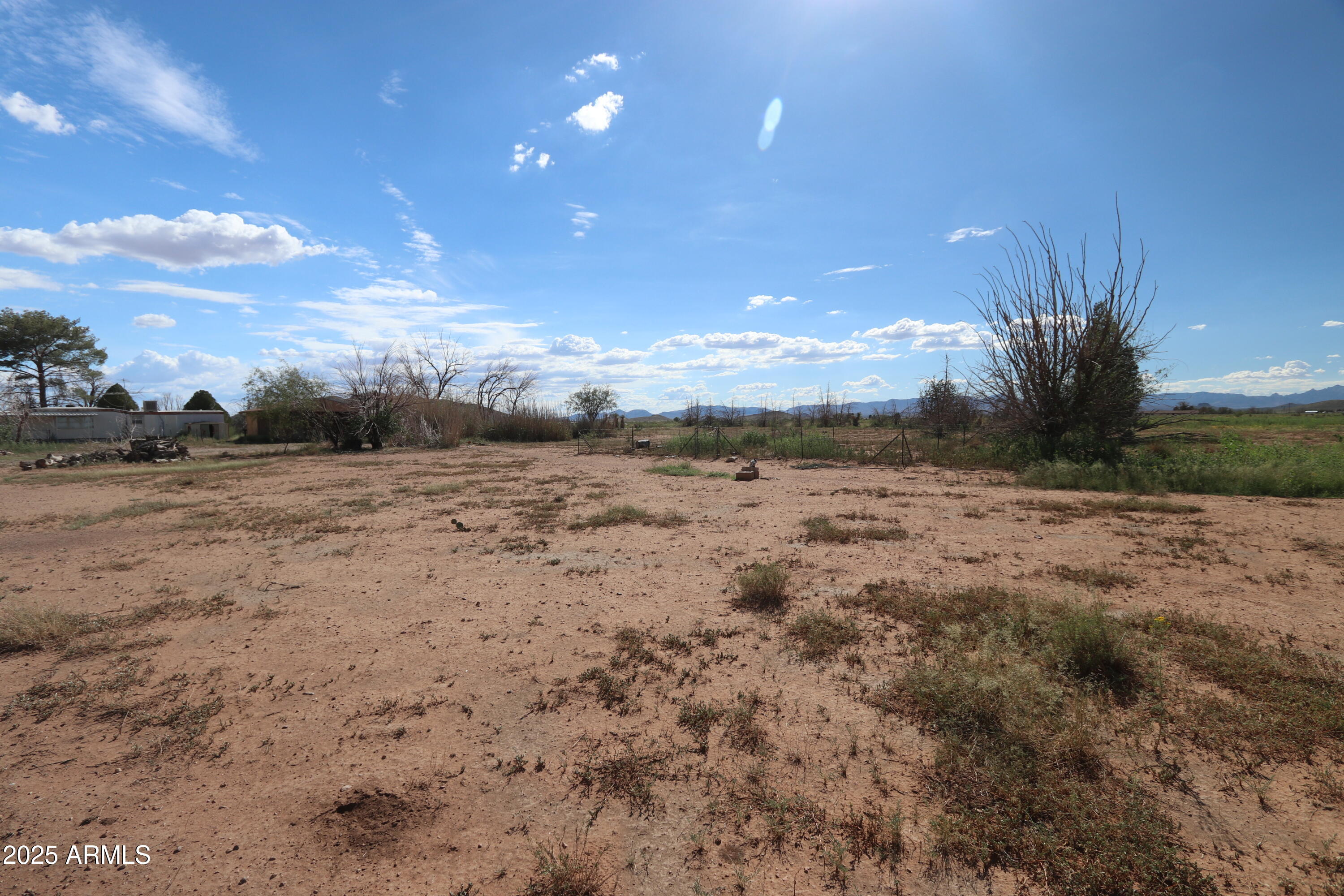 6286 East Mockingbird Road, Unit 8 Pearce, AZ 85625 - Photo 9 of 28 a view of a dry yard with wooden fence