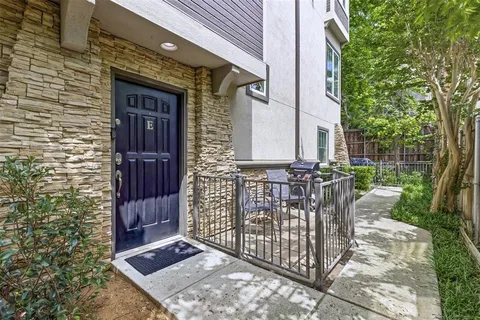 a view of backyard with barbeque grill and wooden fence