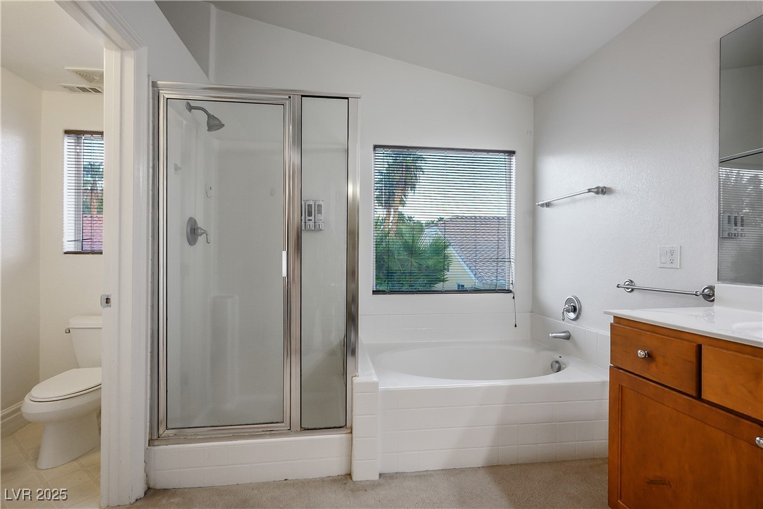 6632 Babys Tear Place Las Vegas, NV 89148 - Photo 8 of 27 Full bath featuring vanity, a stall shower, a garden tub, and vaulted ceiling