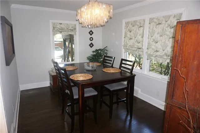a view of a dining room with furniture and chandelier