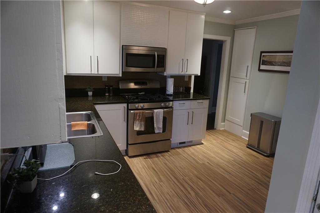 2210 Lenox Road Northeast Atlanta, GA 30324 - Photo 8 of 22 a kitchen with a stove and a microwave