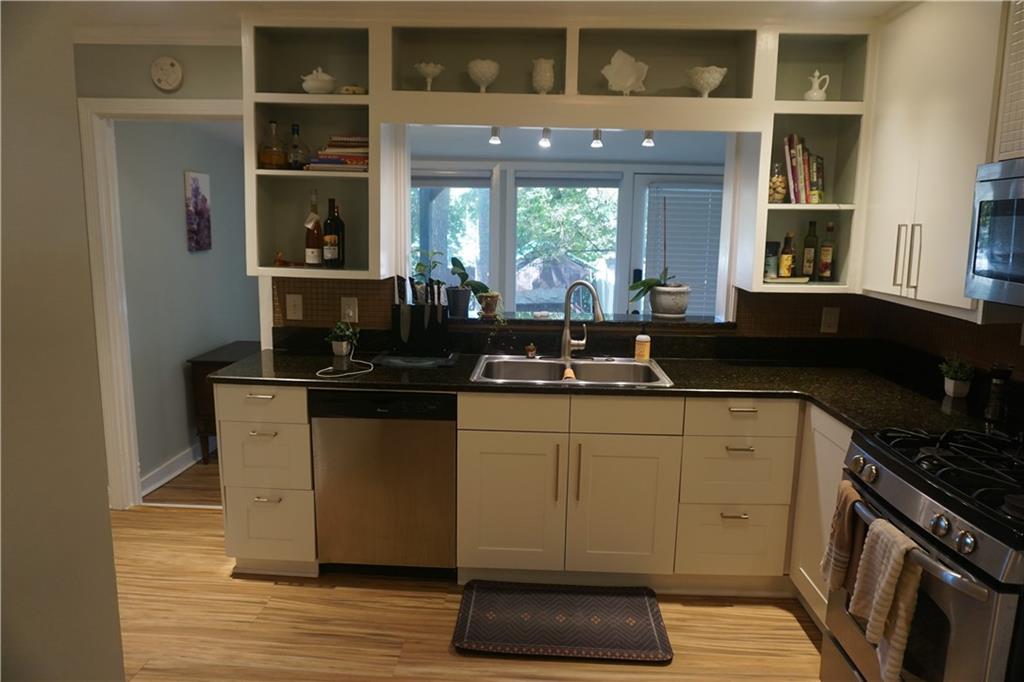 2210 Lenox Road Northeast Atlanta, GA 30324 - Photo 9 of 22 a kitchen with a sink and wooden cabinets