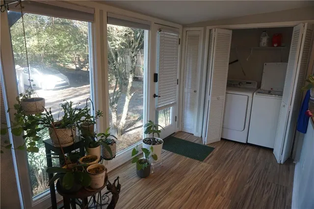 a living room with furniture and a floor to ceiling window