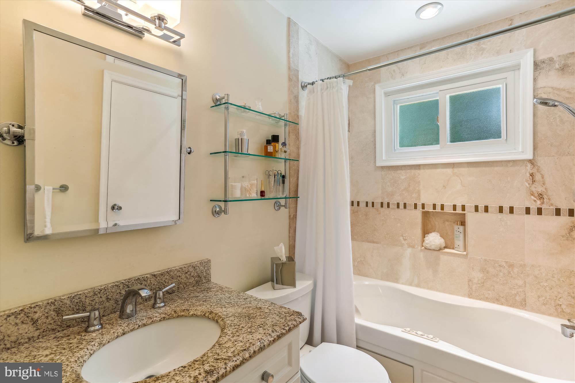 4010 Delancy Drive Silver Spring, MD 20906 - Photo 25 of 63 Upstairs Bath with natural travertine tiling