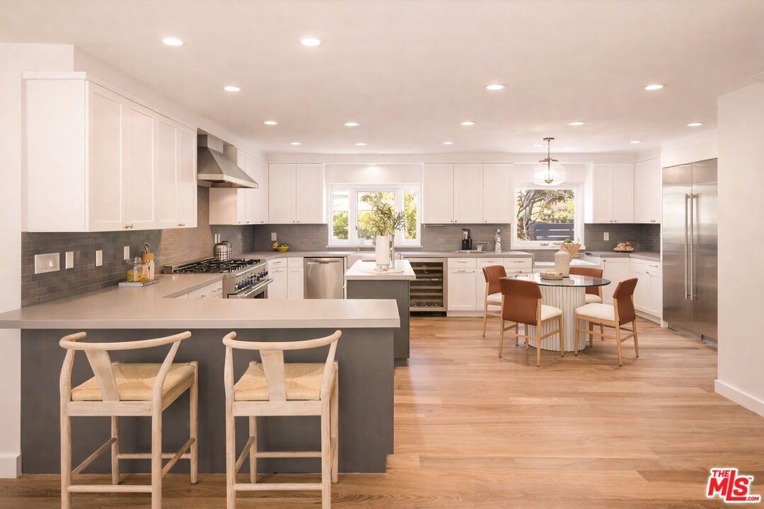 576 East Channel Road Santa Monica, CA 90402 - Photo 12 of 22 a large kitchen with a table and chairs
