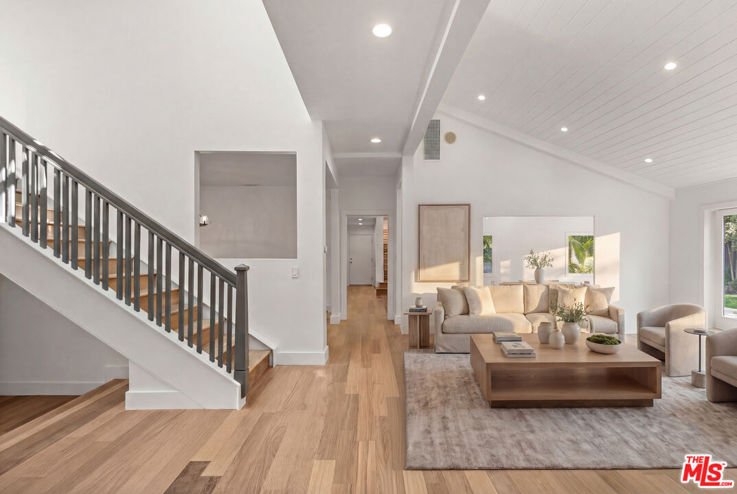 576 East Channel Road Santa Monica, CA 90402 - Photo 14 of 22 a living room with furniture and a dining table with wooden floor