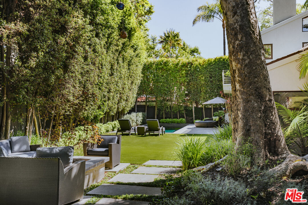 576 East Channel Road Santa Monica, CA 90402 - Photo 18 of 22 a view of a house with backyard sitting area and garden