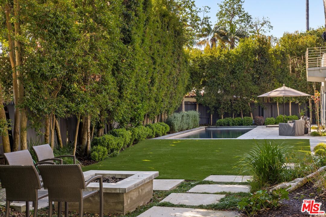 576 East Channel Road Santa Monica, CA 90402 - Photo 19 of 22 a view of a house with backyard sitting area and garden