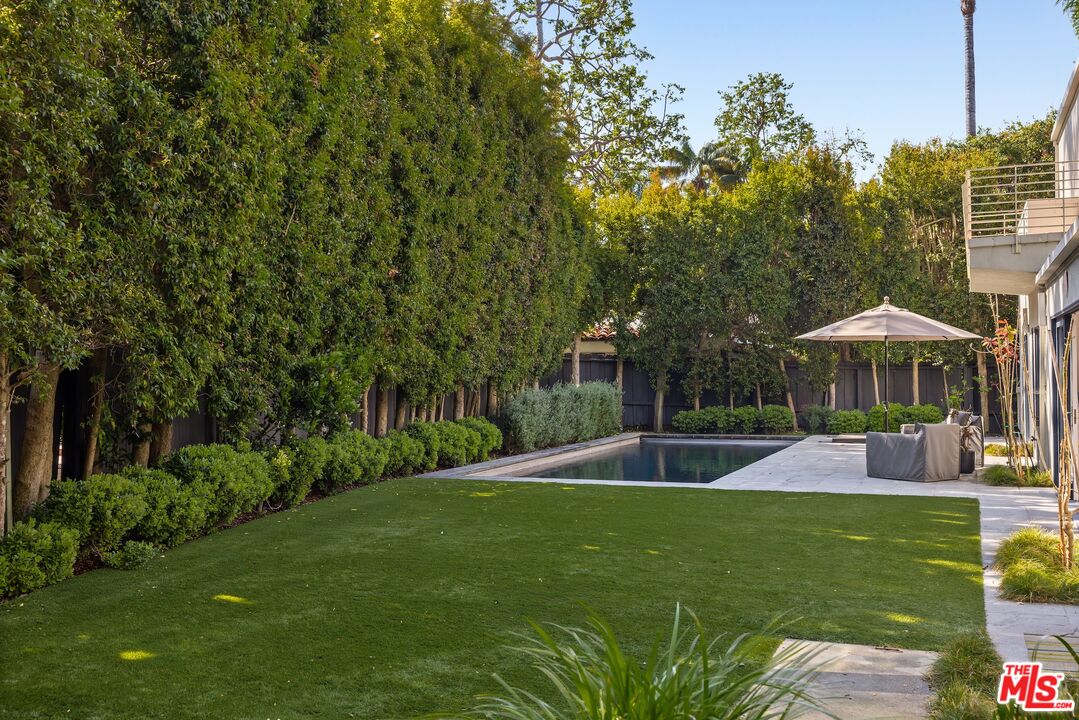 576 East Channel Road Santa Monica, CA 90402 - Photo 20 of 22 a view of a patio with a table and chairs under an umbrella