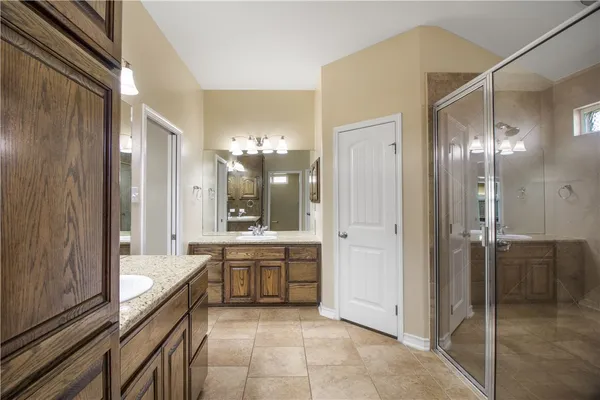 a large bathroom with a large mirror vanity and shower