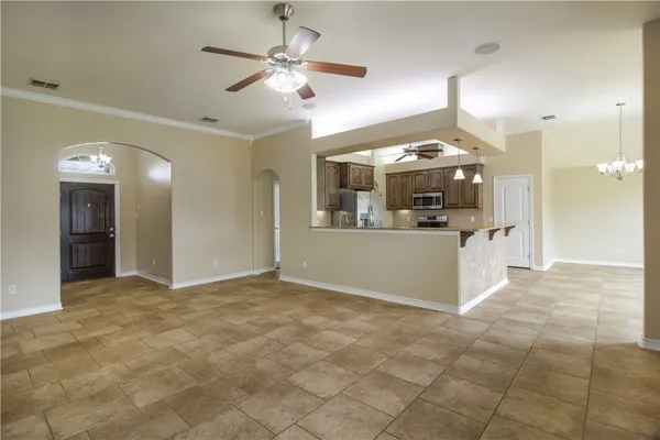 a view of a kitchen with a sink and cabinet chandelier fan