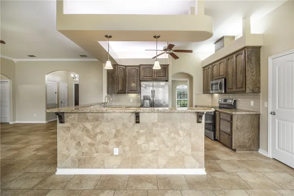 a large kitchen with cabinets and stainless steel appliances