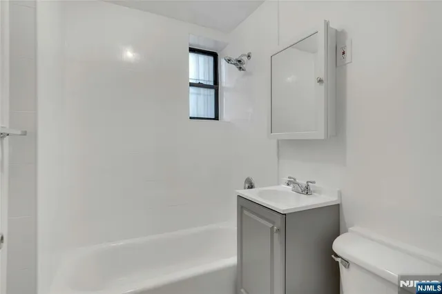 a bathroom with a sink toilet and vanity