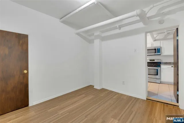 a view of a kitchen with wooden floor