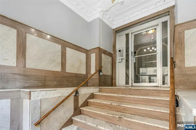 a view of staircase with white walls and windows