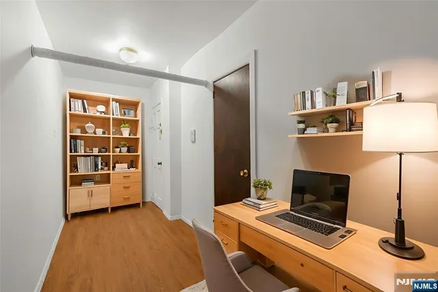 a bedroom with a bed and a desk