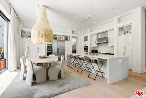 a dining room with furniture a window and a kitchen view