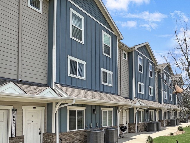 a view of a brick house with many windows and yard