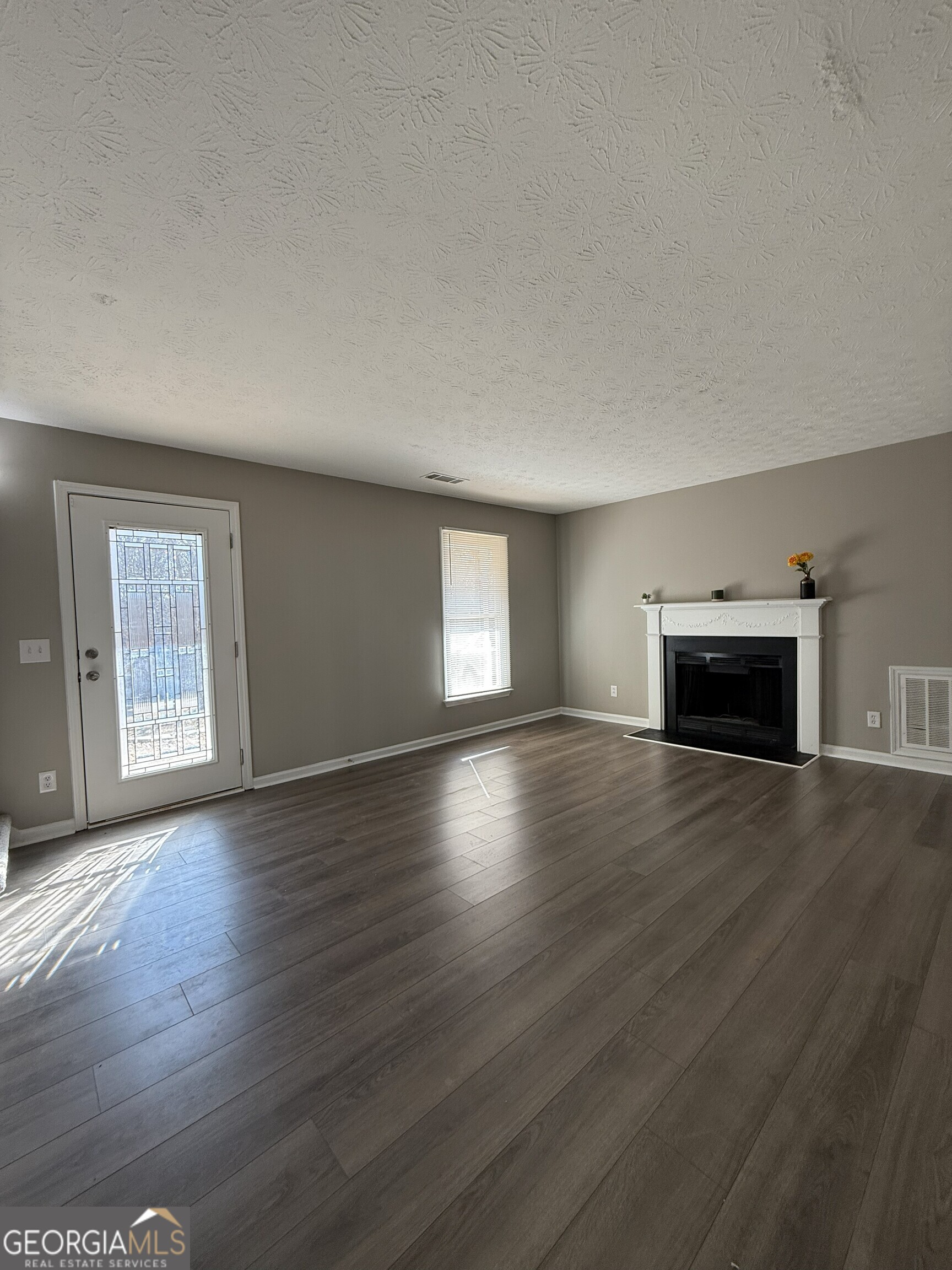 1528 Willow Gate Way Auburn, GA 30011 - Photo 2 of 24 a view of empty room with wooden floor and fireplace