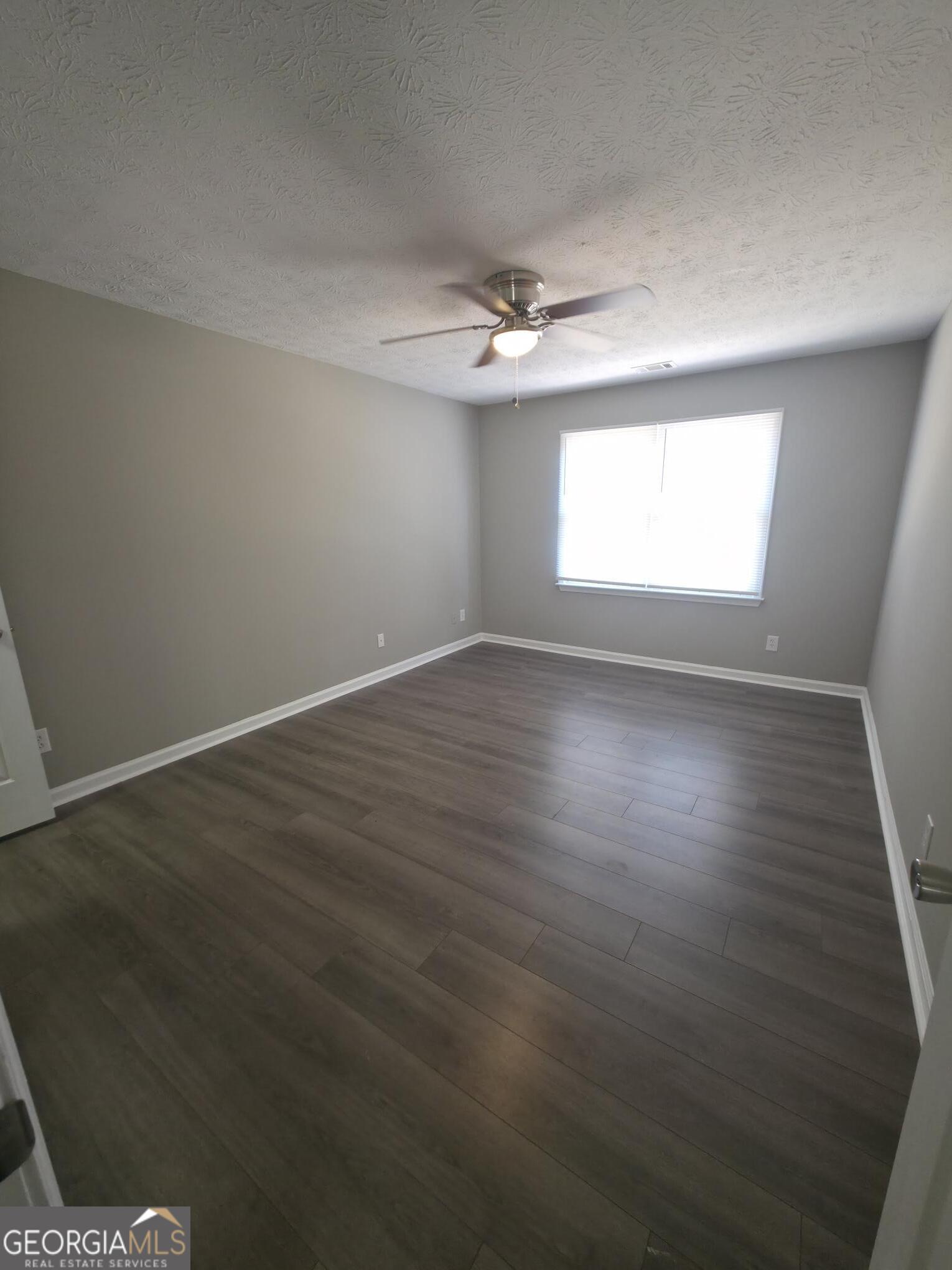 1528 Willow Gate Way Auburn, GA 30011 - Photo 6 of 24 an empty room with wooden floor and windows