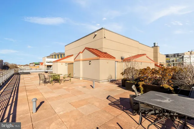 a view of a terrace with chairs and potted plants