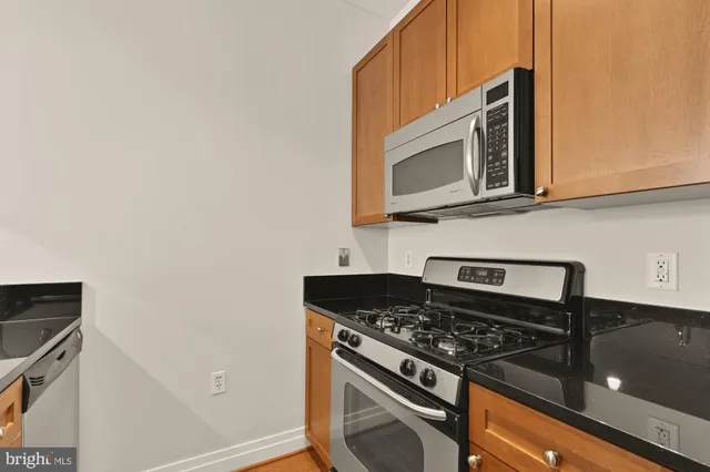 a stove top oven sitting inside of a kitchen