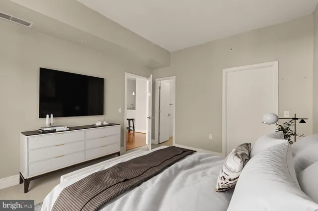 a bedroom with a bed and a flat screen tv