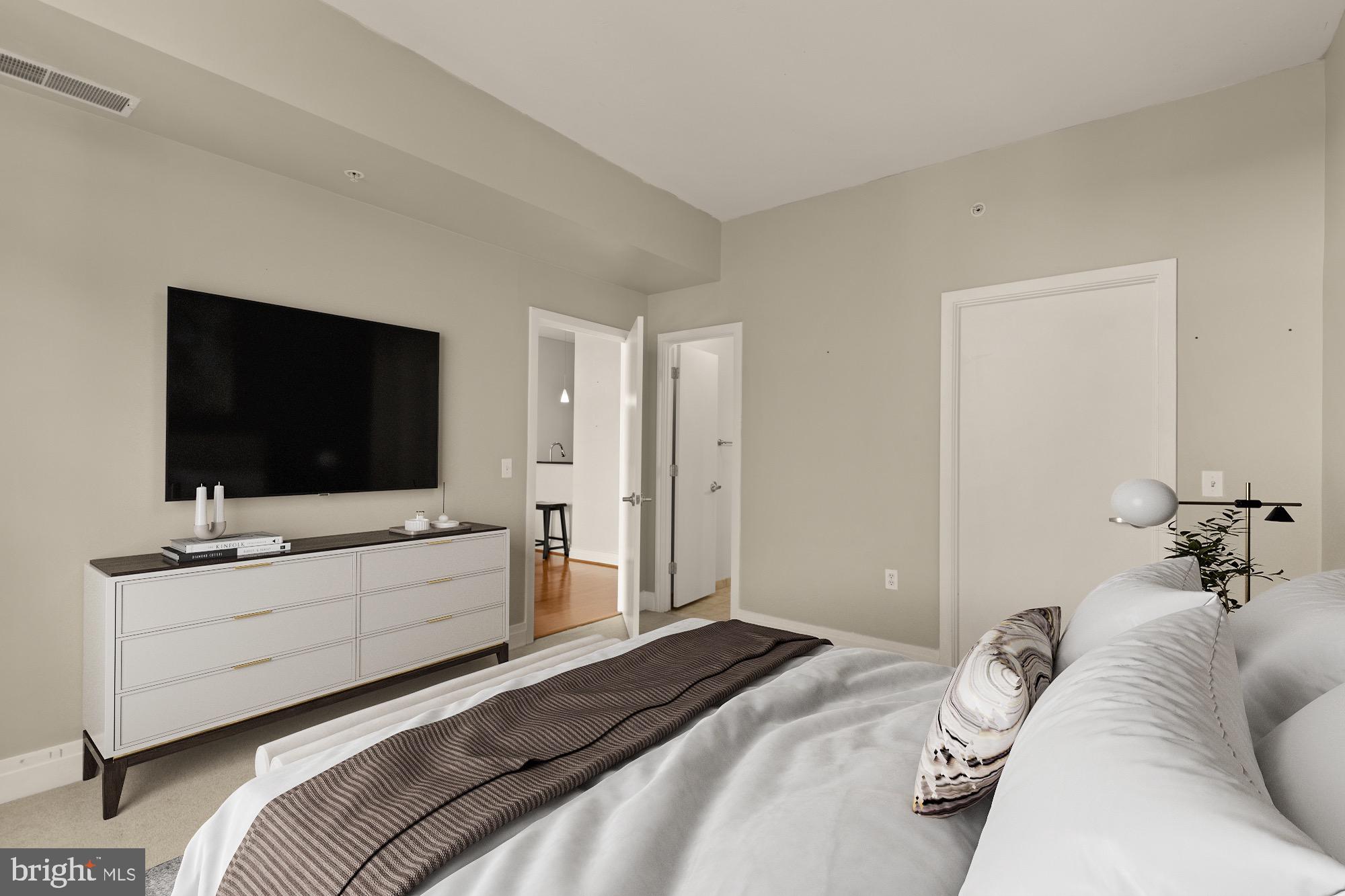 2120 Vermont Avenue Northwest, Unit 411 Washington, DC 20001 - Photo 6 of 27 a bedroom with a bed and a flat screen tv