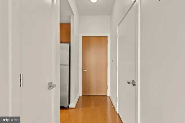 a view of a hallway with wooden floor