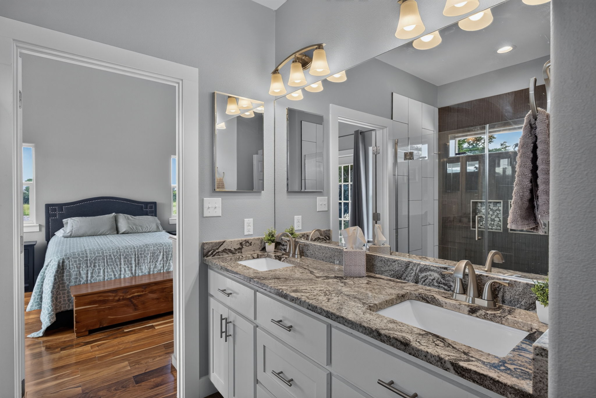 207 Deer Ridge Drive Burnet, TX 78611 - Photo 25 of 36 Double vanity with stone countertops and a spacious walk-in shower provide a luxurious experience in primary bath