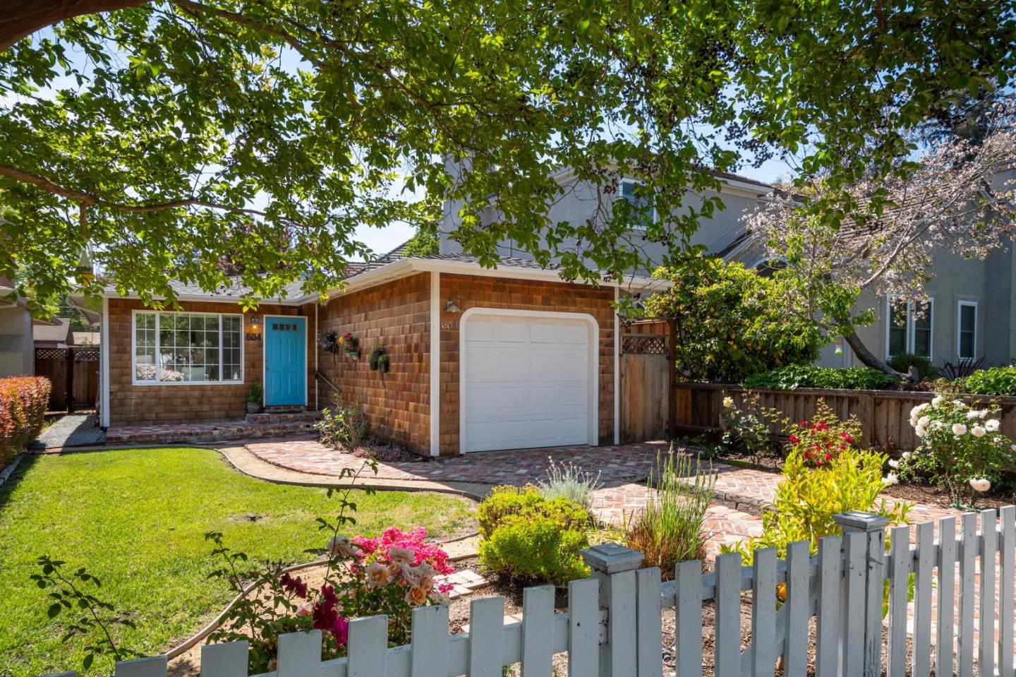 a front view of house with yard and trees