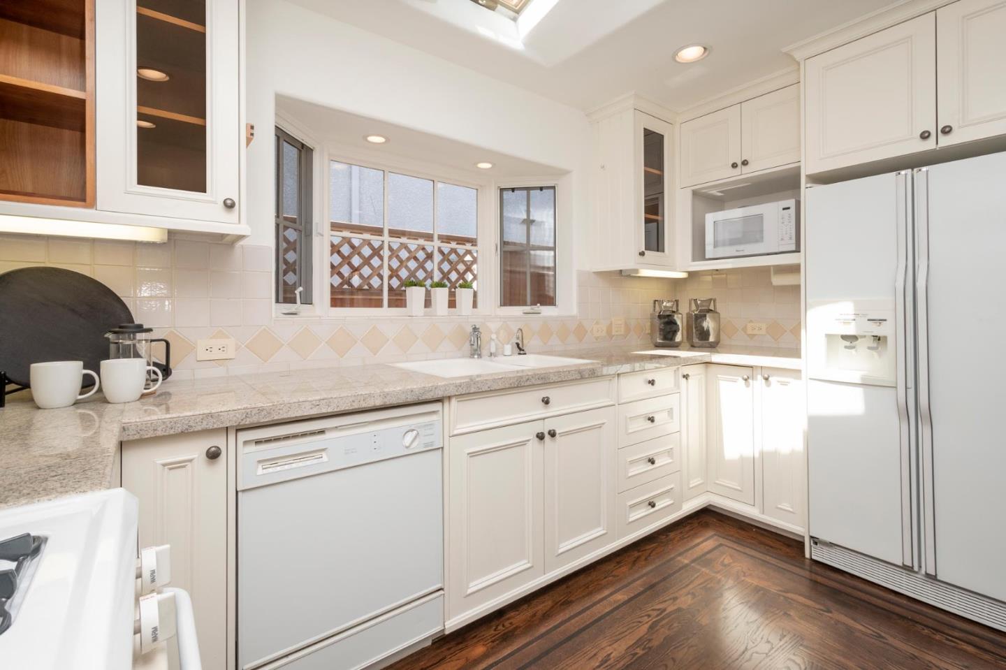 604 9th Avenue Menlo Park, CA 94025 - Photo 16 of 28 a kitchen with granite countertop white cabinets and white appliances